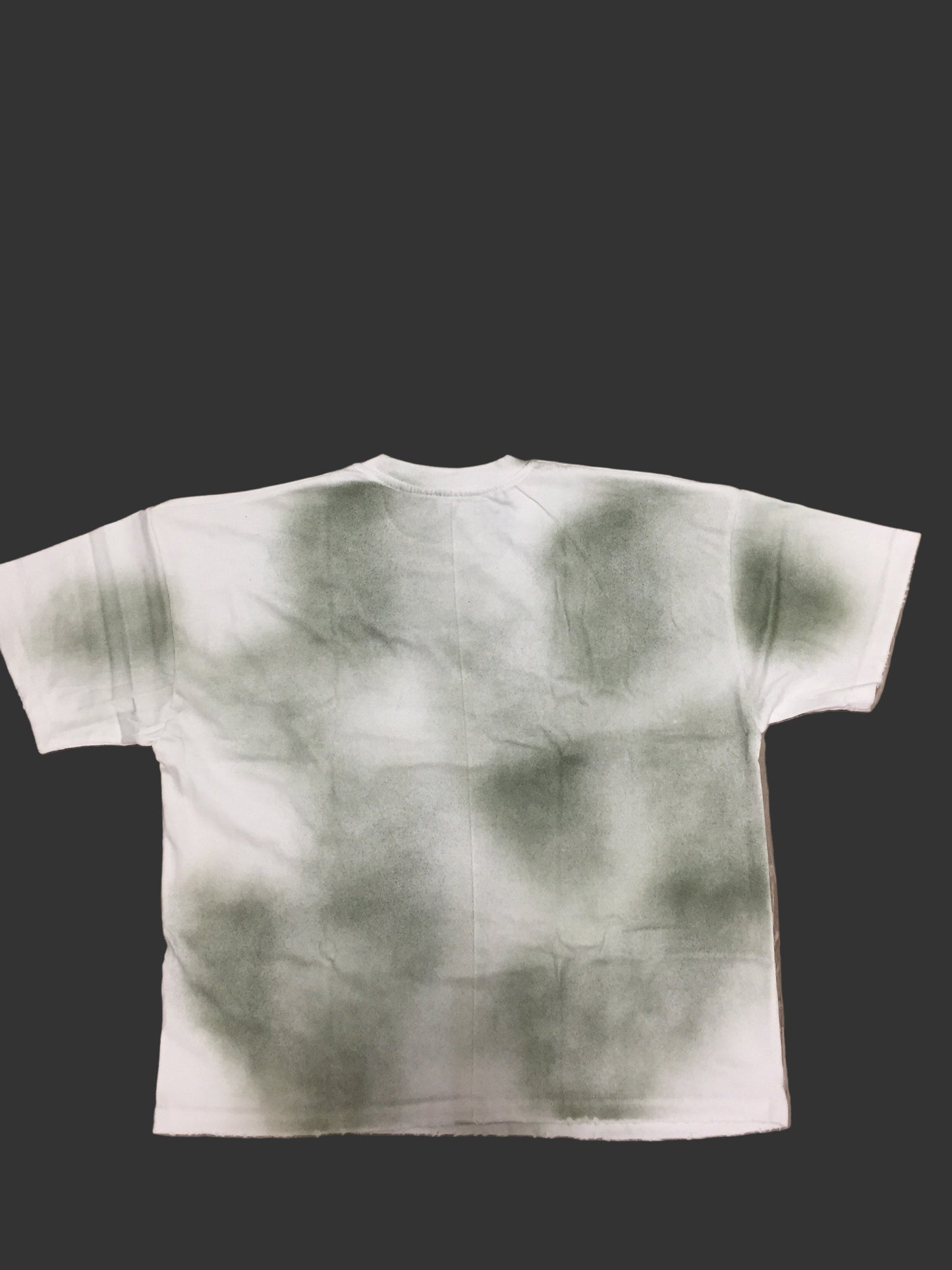 White garment with greenish-brown abstract pattern