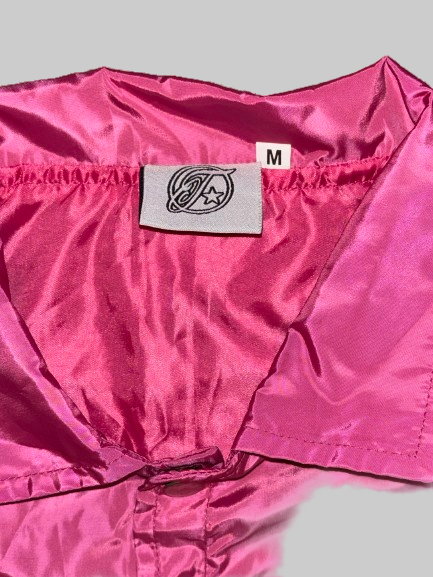 Close-up of a pink jacket with a brand label on a white background