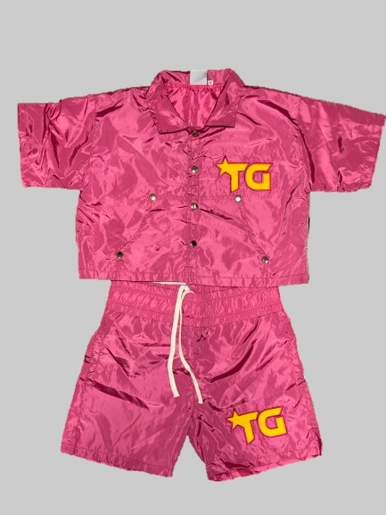 Pink jacket and shorts set with 'TG' logo on a white background